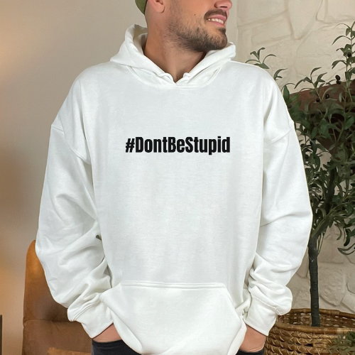 A man in a white hoodie, showcasing the #Don'tBeStupid Crew heavy blend hooded sweatshirt by Worlds Worst Tees. Thick cotton-polyester fabric, kangaroo pocket, classic fit. Ideal for warmth and comfort.