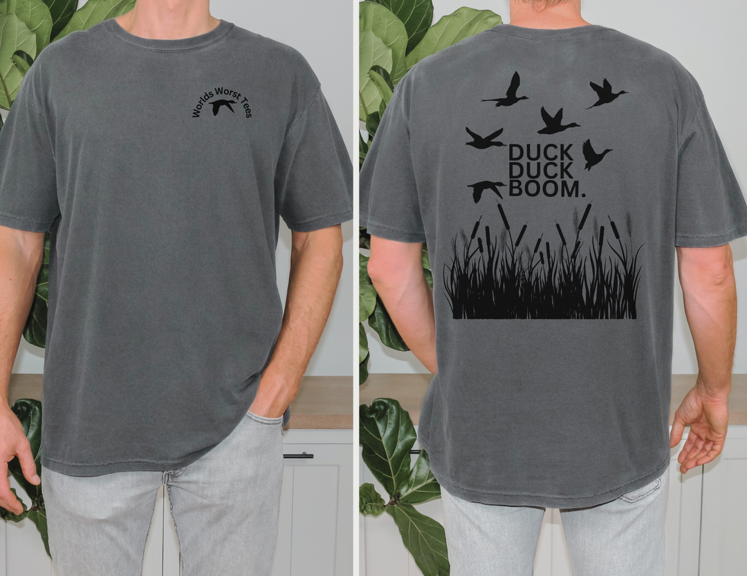 A premium fitted men's tee, the Duck Duck Boom Tee features a silhouette of a duck and grass. Combed, ring-spun cotton with ribbed knit collar for a comfy, light fit. Sizes XS to 4XL.