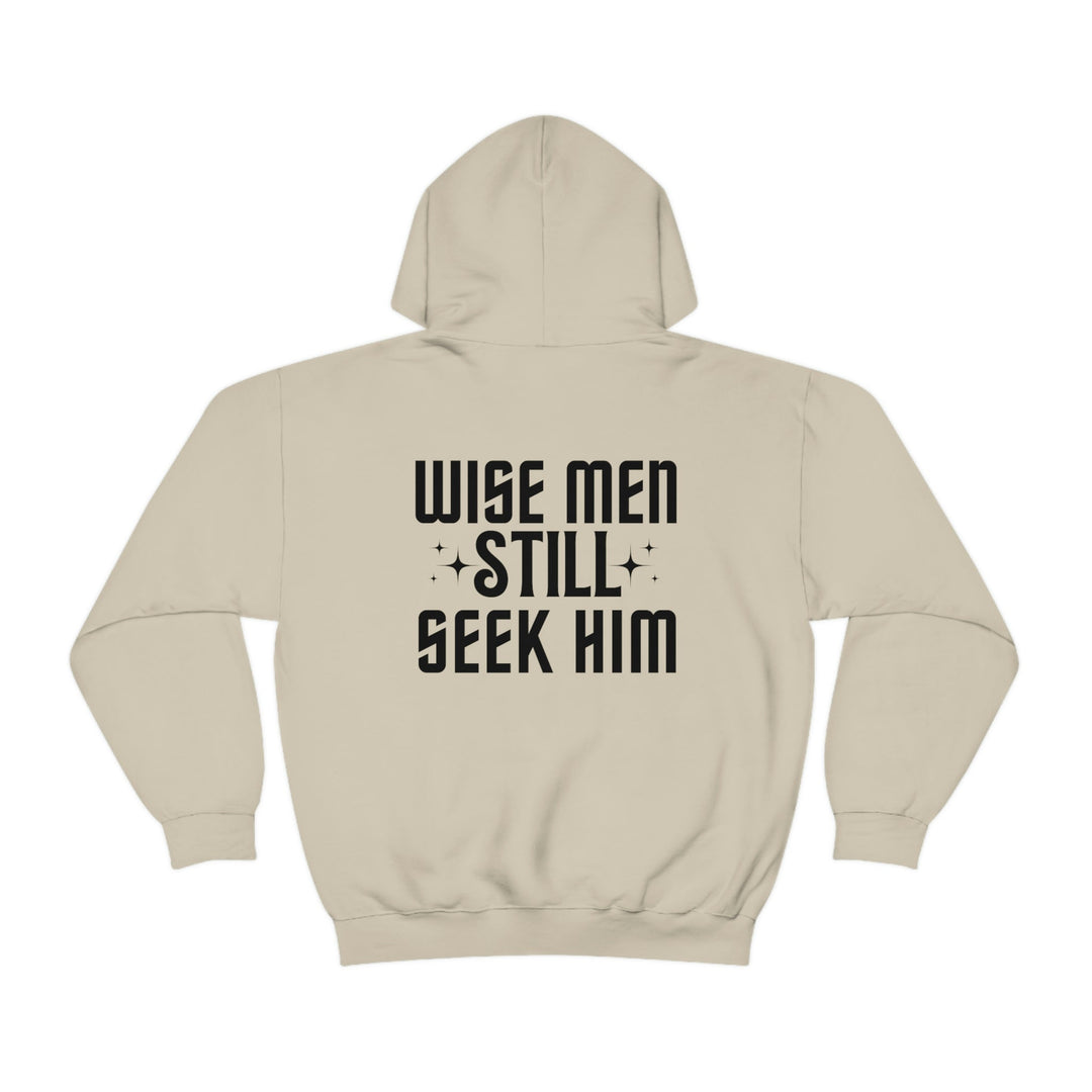 A white hoodie with black text, featuring Wise Men Still Seek Him. Unisex heavy blend of cotton and polyester, plush and warm, with kangaroo pocket and drawstring hood. From Worlds Worst Tees.