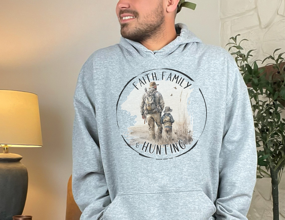 A man in a grey Faith Family Hunting Hoodie, with a kangaroo pocket and drawstring hood, made of cotton and polyester blend for comfort and warmth. Classic fit, tear-away label, suitable for printing.