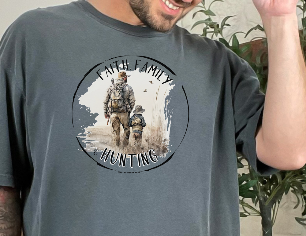 A man in a relaxed fit Faith Family Hunting Tee, showcasing a garment-dyed, ring-spun cotton fabric. Double-needle stitching ensures durability, while the lack of side-seams maintains a tubular shape.
