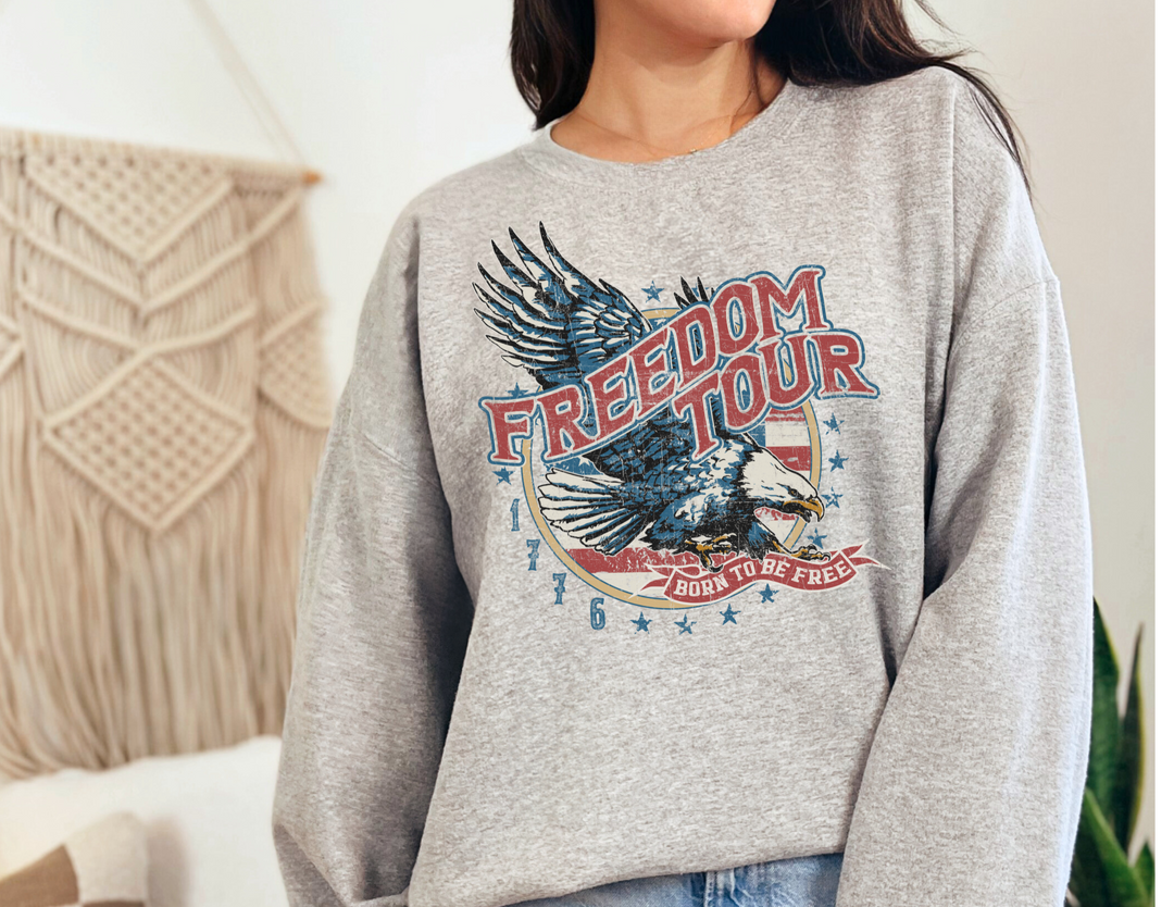 A unisex heavy blend crewneck sweatshirt, the Freedom Tour Crew, offers comfort and style. Made of 50% cotton and 50% polyester with a ribbed knit collar, loose fit, and no itchy side seams. Ideal for any situation.