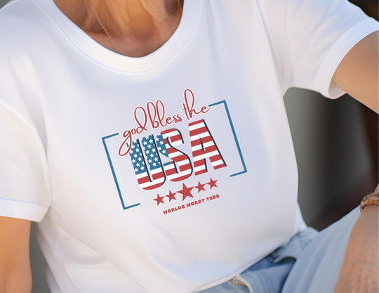 A patriotic tee featuring a person in a white shirt with a red and white design, embodying the God Bless the USA theme. Unisex jersey tee with ribbed knit collars, taping on shoulders, and 100% cotton fabric.