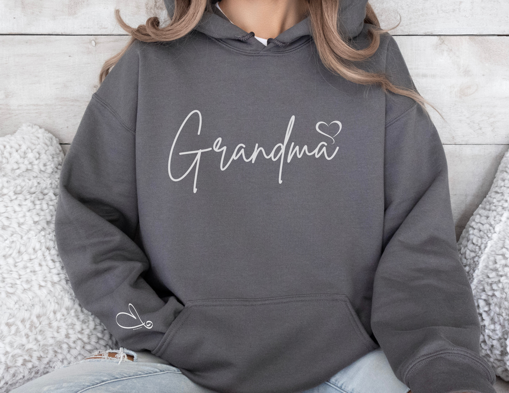 A cozy Grandma Love Hoodie in grey, featuring a person wearing it, a kangaroo pocket, and a matching drawstring. Unisex, cotton-polyester blend for warmth and comfort. Ideal for chilly days.