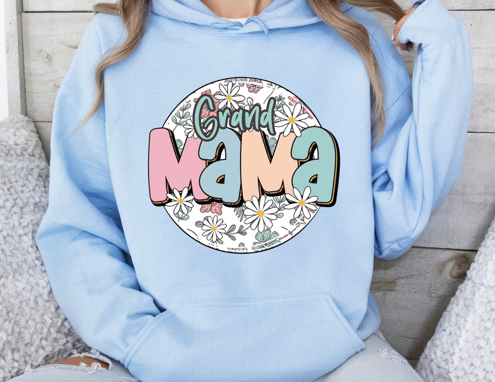 A person in a blue hoodie with a kangaroo pocket, showcasing the Sassy Grand Mama Flower Hoodie from Worlds Worst Tees. Made of cotton and polyester, cozy for cold days. Sizes from S to 5XL.