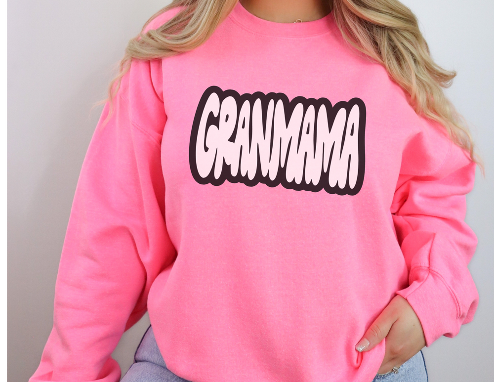 A heavy blend crewneck sweatshirt, Granmama Crew, in pink, featuring ribbed knit collar for shape retention. Unisex, 50% cotton, 50% polyester, loose fit, medium-heavy fabric. Sizes S-5XL.