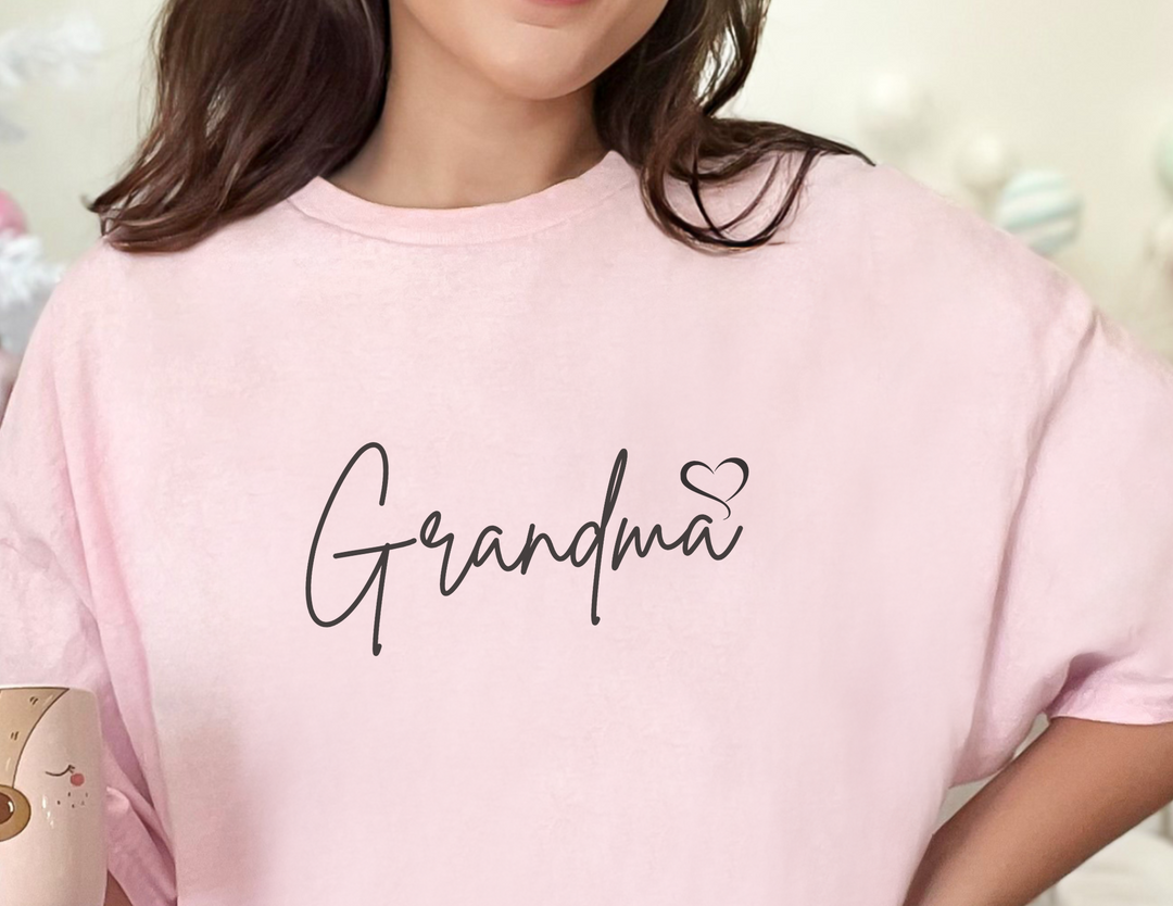 A classic Grandma Love Tee, a staple for casual fashion, featuring a person in a pink shirt. Unisex, 100% cotton, with ribbed knit collar for a comfortable fit. Sizes S-5XL.
