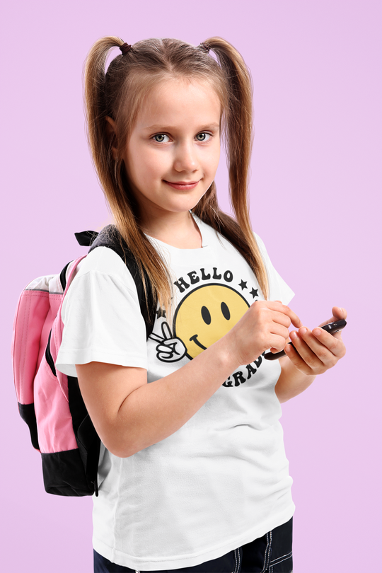 Hello 8th Grade Tee: A girl with pigtails smiling, holding a phone. Premium men's short sleeve tee in light fabric, ribbed knit collar, roomy fit, and 100% combed cotton.