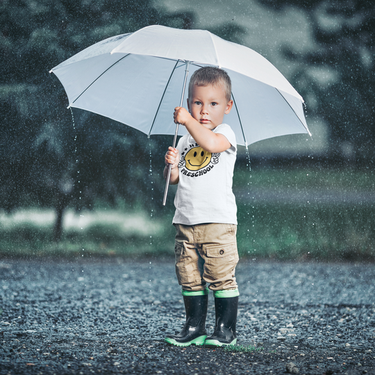 Hello Preschool Toddler Tee featuring a child holding an umbrella in the rain. Made of 100% combed ringspun cotton, light fabric, classic fit, tear-away label. Perfect for sensitive skin. Sizes: 2T, 3T, 4T, 5-6T.