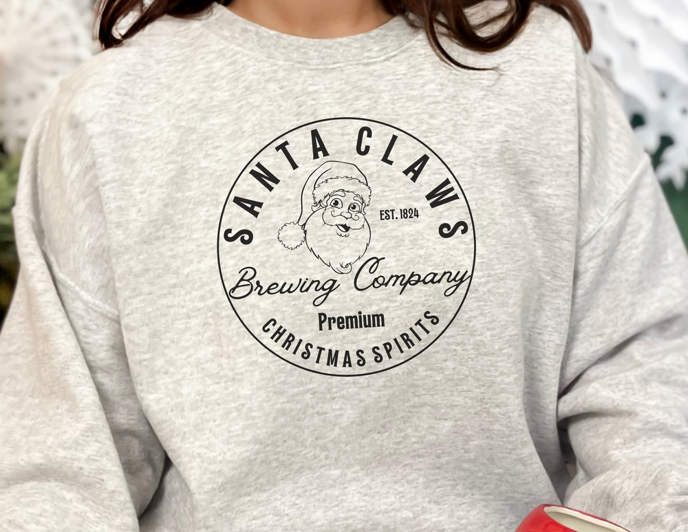 A Santa Claws Crewneck sweatshirt in black, featuring a Santa Claus face logo and bold lettering. Unisex, heavy blend fabric for comfort, ribbed knit collar, and no itchy side seams.