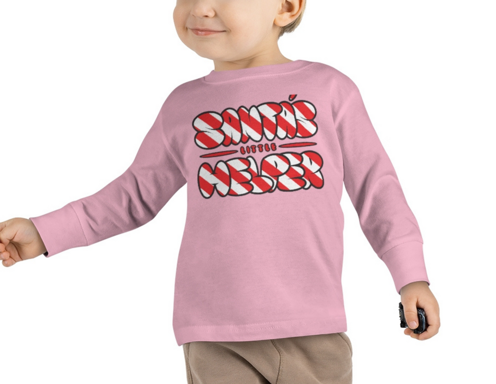 A toddler in a pink Santa's Little Helper long sleeve tee, perfect for sensitive skin. Made of 100% combed ringspun cotton, light fabric, classic fit, tear-away label, true to size.