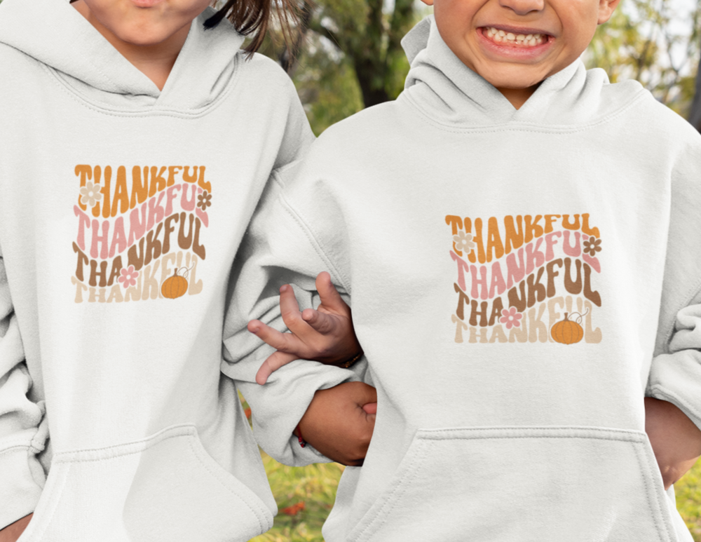 Youth blend hooded sweatshirt with kangaroo pocket and twill taping. Ultra-soft, preshrunk fleece (50% cotton 50% polyester) in regular fit. Sizes S-XL. Thankful Youth Hoodie by Worlds Worst Tees.