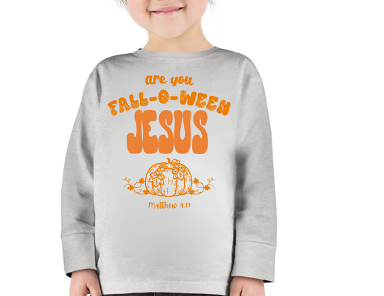 Child wearing a FALL-O-WEEN Jesus themed long-sleeve tee, featuring a pumpkin illustration and Matthew 4:19. Cozy, durable, toddler crew from Worlds Worst Tees.