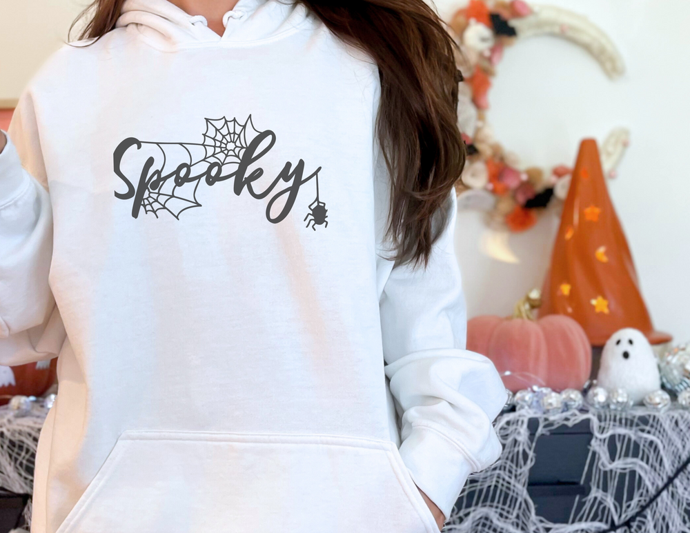 Alt text: Spooky Hoodie: Unisex heavy blend hooded sweatshirt in white, featuring kangaroo pocket, drawstring hood, and cotton-polyester fabric for plush warmth. Classic fit, ideal for cold days.