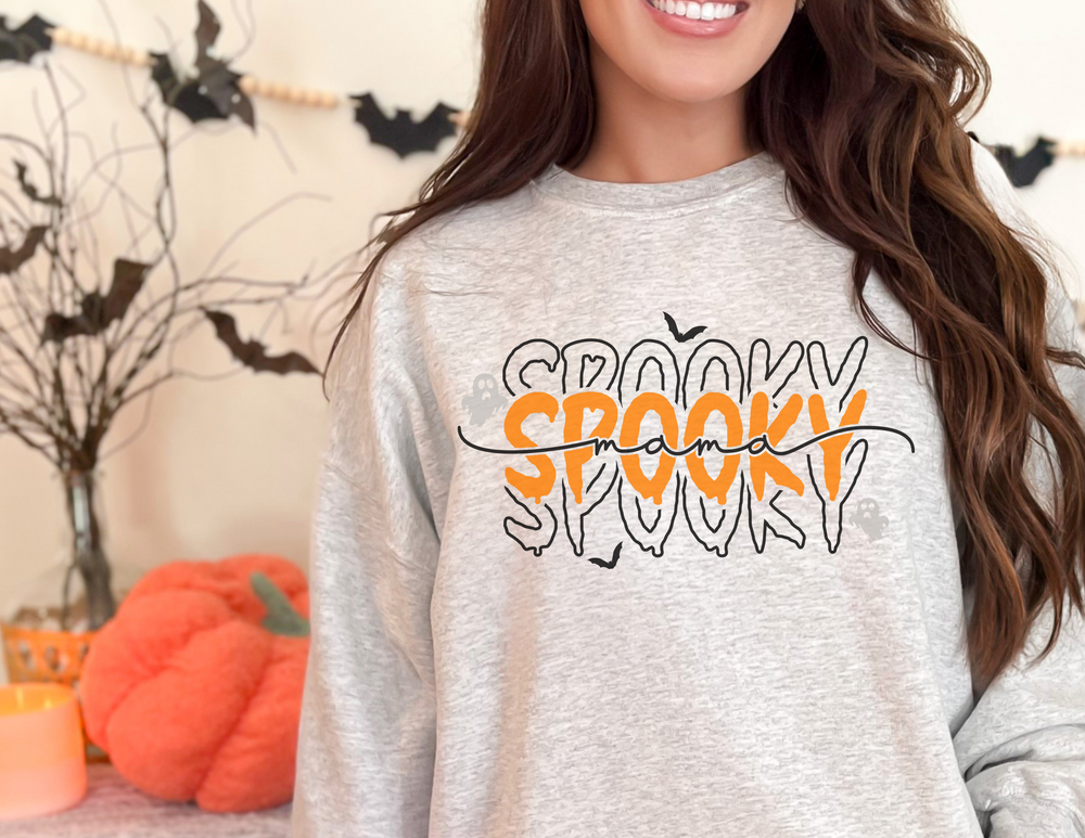 A unisex heavy blend crewneck sweatshirt, the Spooky Mama Crewneck, offers comfort with ribbed knit collar, no itchy seams, and a loose fit. Made of 50% cotton, 50% polyester. Sizes S-5XL.