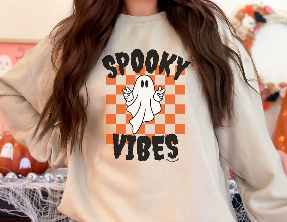 A unisex heavy blend crewneck sweatshirt featuring a ghost design, ideal for spooky vibes. Made of 50% cotton, 50% polyester with ribbed knit collar and no itchy side seams. From Worlds Worst Tees.