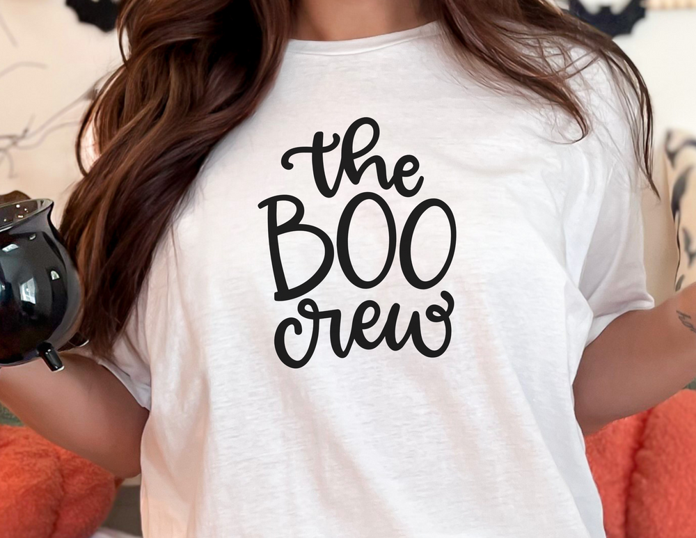 A relaxed fit BOO Crew Tee in white, featuring a black graphic print. Made of 100% ring-spun cotton, garment-dyed for coziness, with double-needle stitching for durability and a seamless design for comfort.