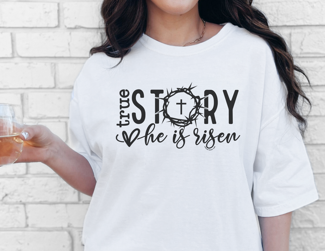 A relaxed fit True Story He is Risen Tee in white, made of 100% ring-spun cotton. Garment-dyed for coziness, with double-needle stitching for durability. No side-seams for a tubular shape.