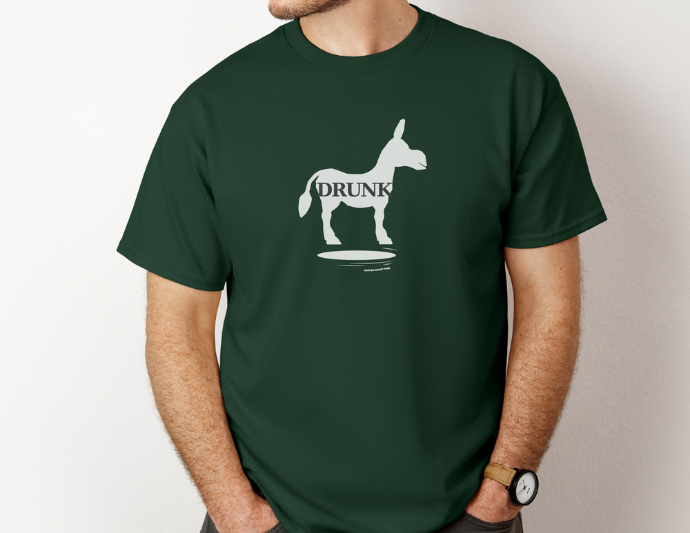 A man wearing a green Drunk Ass Hole tee, featuring a donkey graphic. Unisex heavy cotton tee with no side seams, ribbed knit collar, and durable tape on shoulders. Classic fit, 100% cotton.