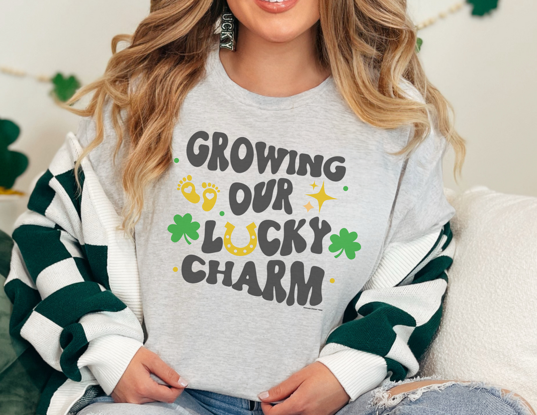 A woman wearing a white shirt with words on it, smiling at the camera. Unisex Lucky Charm Tee made of 100% cotton, offering comfort and durability. Ideal for casual fashion with personalized designs.