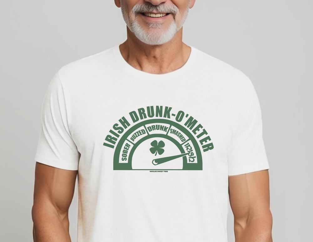 A man in a white shirt with a green gauge featuring a four-leaf clover, smiling. Unisex heavy cotton tee, Irish Drunk O'Meter design. Classic fit, ribbed collar, durable tape shoulders. Sizes S-5XL.