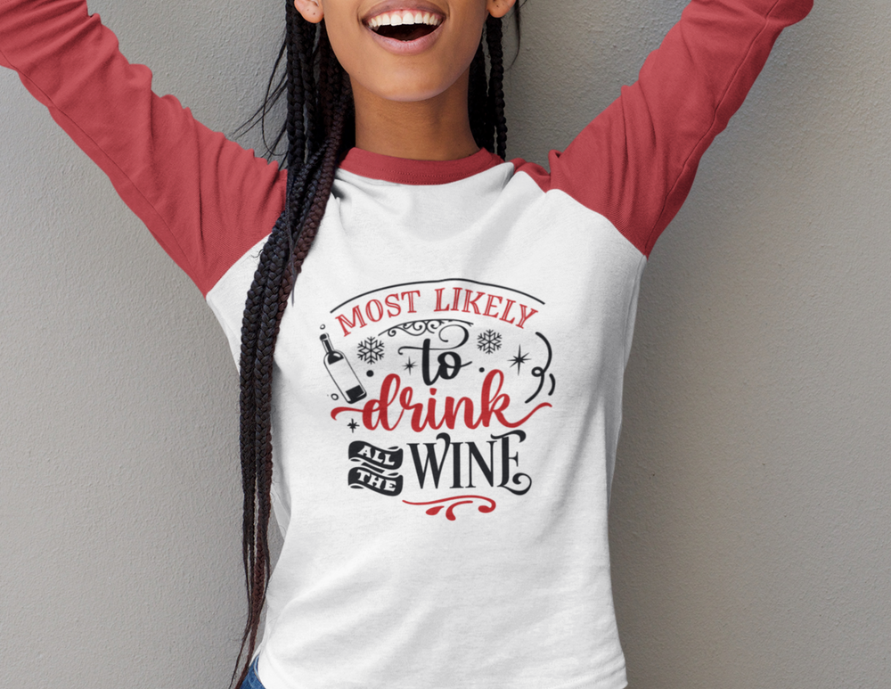 A smiling woman in a loose-fit Raglan sleeve tee, featuring Drink All the Wine text. Unisex style for a stylish home run. Made of polyester, combed ringspun cotton, and rayon blend.