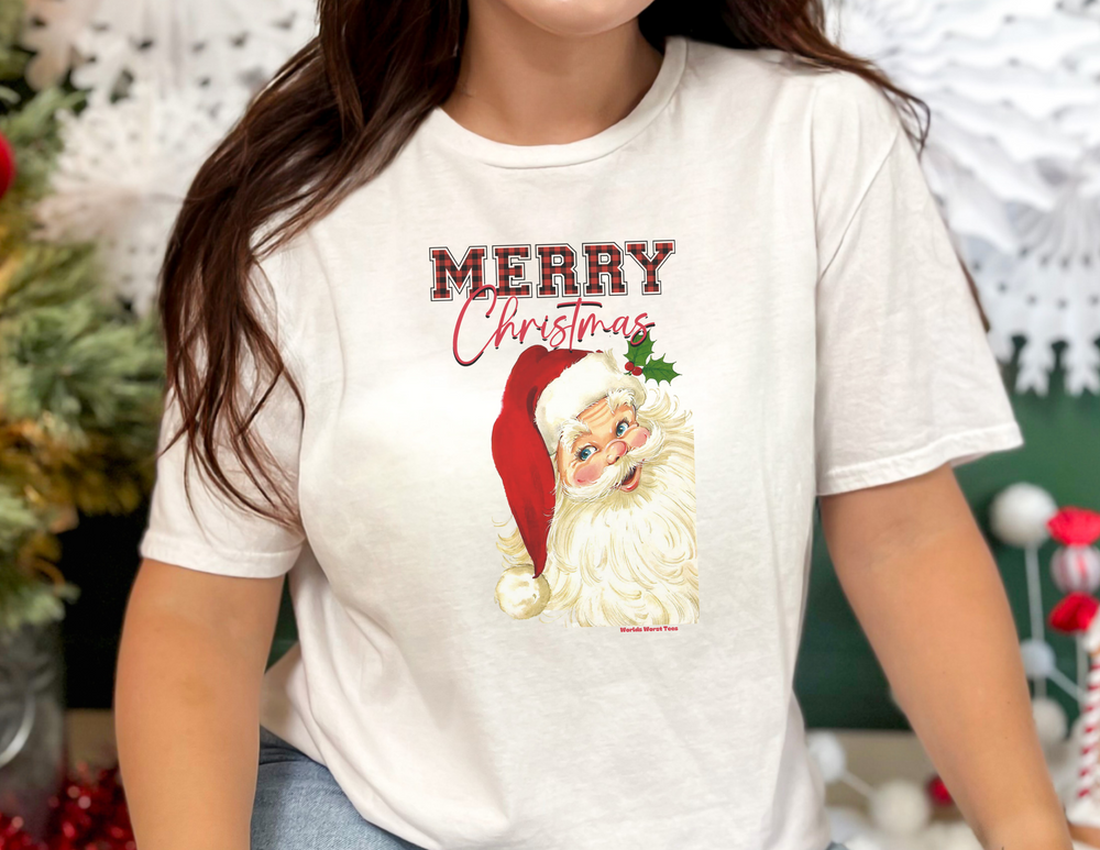 A Christmas Santa Tee, featuring a woman in a white shirt with a festive Santa Claus design. Unisex jersey tee with ribbed knit collar, 100% cotton, and light fabric. Sizes XS to 5XL.