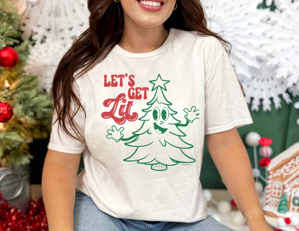 A unisex Let's Get Lit Tee sweatshirt in white, featuring a cartoon Christmas tree design. Made of 80% ring-spun cotton and 20% polyester, with a relaxed fit and rolled-forward shoulder.