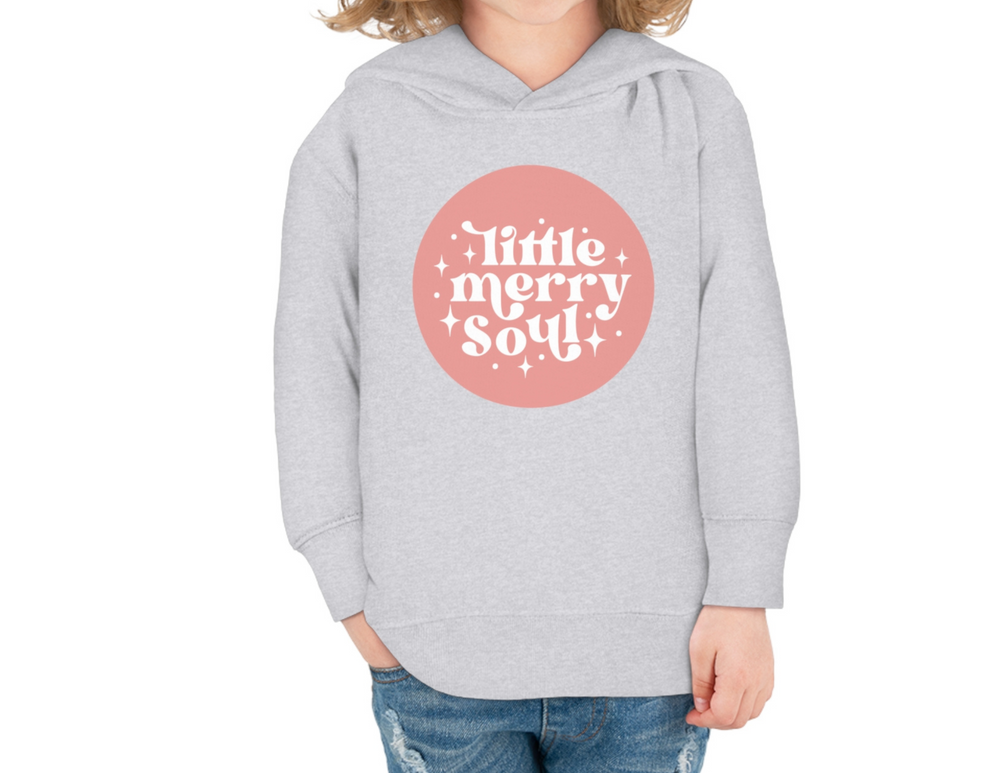 A Rabbit Skins toddler hoodie with a pink circle and white text, designed for comfort with a jersey-lined hood and durable stitching. Perfect for cozy days with side pockets and a soft cotton-polyester blend.