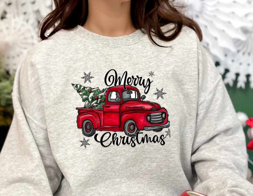 A unisex heavy blend crewneck sweatshirt featuring a red truck and Christmas tree design. Comfortable with ribbed knit collar, no itchy seams. Ideal for festive wear. From Worlds Worst Tees.