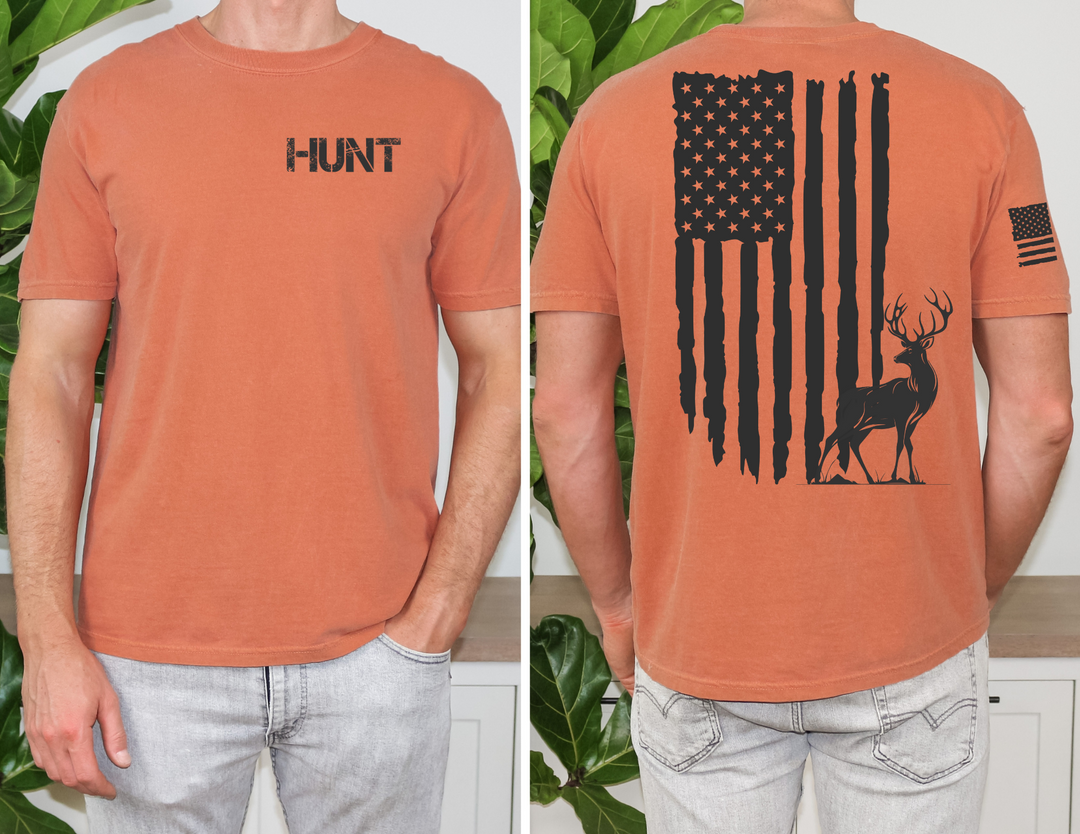 A premium American Hunter Tee for men, featuring a flag and deer design. Comfy, light, and roomy with ribbed knit collar and side seams for durability. 100% combed, ring-spun cotton.