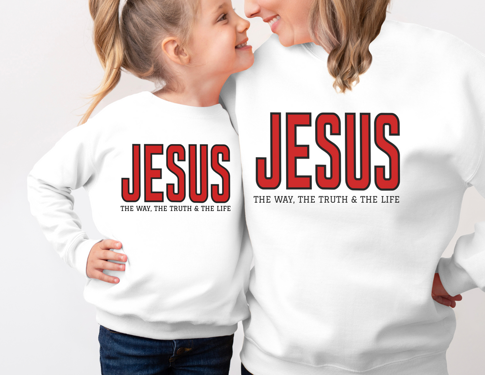 Adult and young girl wearing Jesus, the Way, the Truth, the Life white sweatshirts, smiling at each other, highlighting the cozy toddler crew's design.