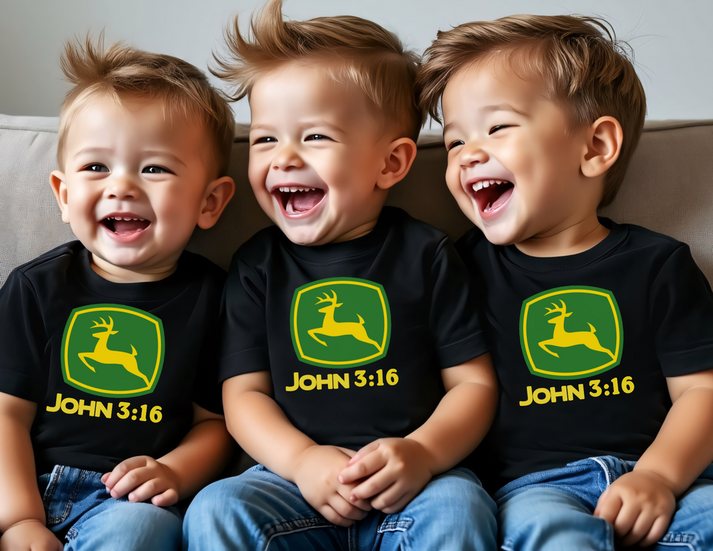 Three toddlers joyfully laugh on a couch, wearing matching John 3:16 Kids Tee with a green-and-yellow deer logo. Perfect for everyday use.