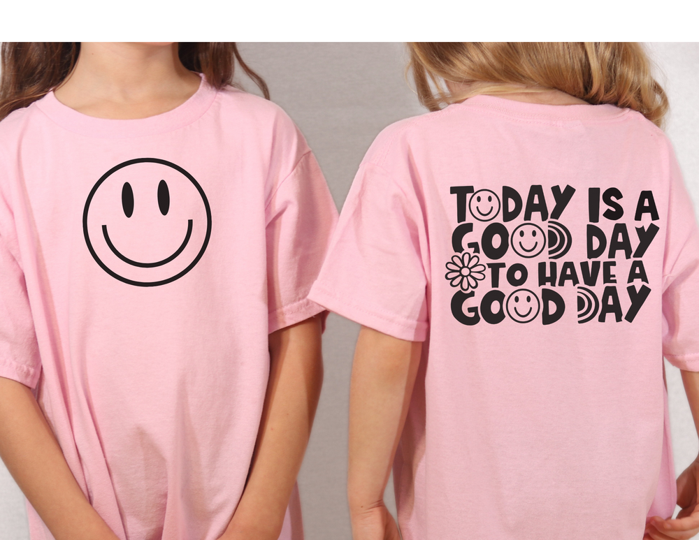 Youth short sleeve tee featuring a girl in a pink shirt with smiley faces. Lightweight and comfortable, perfect for custom artwork. Made of 100% Airlume combed cotton. Retail fit with tear away label.