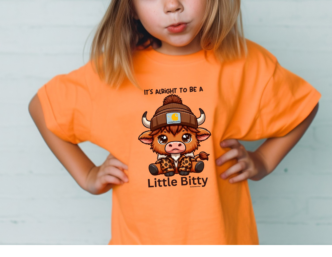 Little Bitty Toddler Tee featuring a girl in an orange shirt with a cow design. Made of 100% combed ringspun cotton, light fabric, tear-away label, and a classic fit. Sizes: 2T, 3T, 4T, 5-6T.
