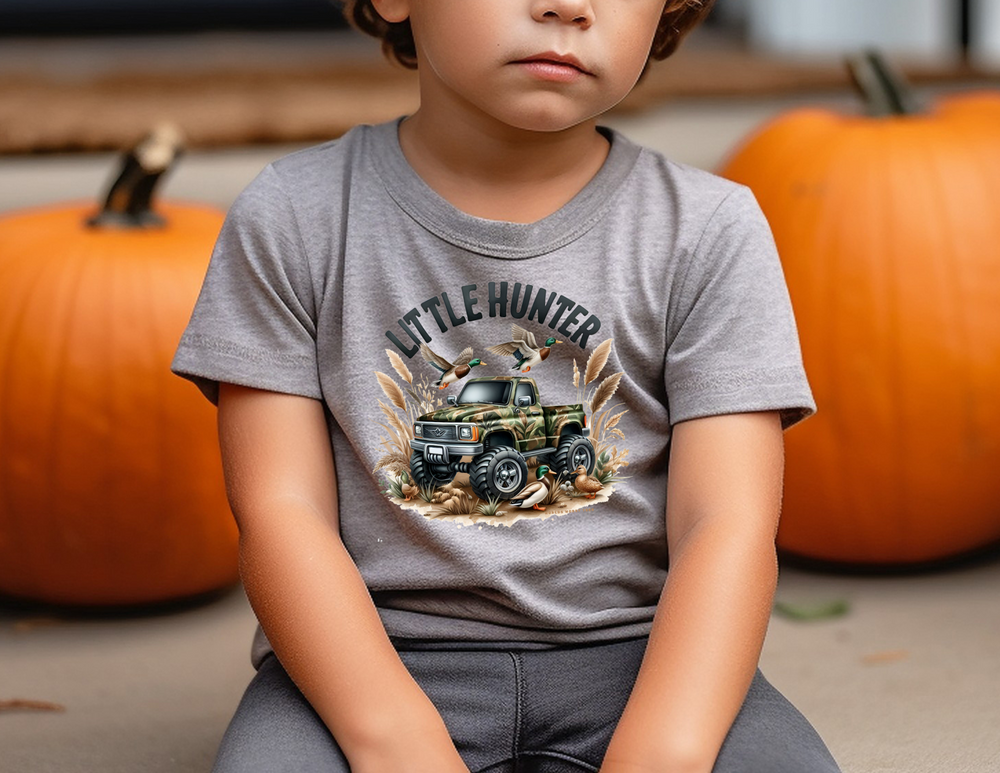 Little Hunter Toddler Tee: A boy sits among pumpkins, embodying fall vibes. Soft, durable 100% cotton tee for sensitive skin, perfect for first adventures. Sizes 2T to 5-6T. Classic fit, tear-away label, true to size.