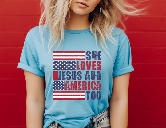 A woman in a casual tee, posing with a blue shirt featuring red and white stripes. She embodies the She Loves Jesus and America Tee vibe, a comfy unisex jersey with ribbed knit collars and taping on shoulders for lasting fit.