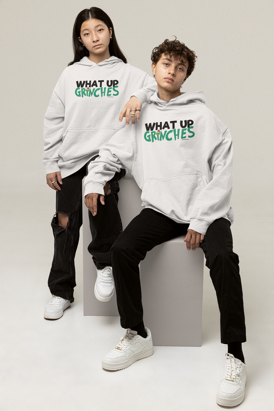 Two men in matching sweatshirts, one wearing a white shoe, showcase the What up Grinches Youth Hoodie by Worlds Worst Tees. Youth blend hooded sweatshirt with kangaroo pocket and reinforced neck.