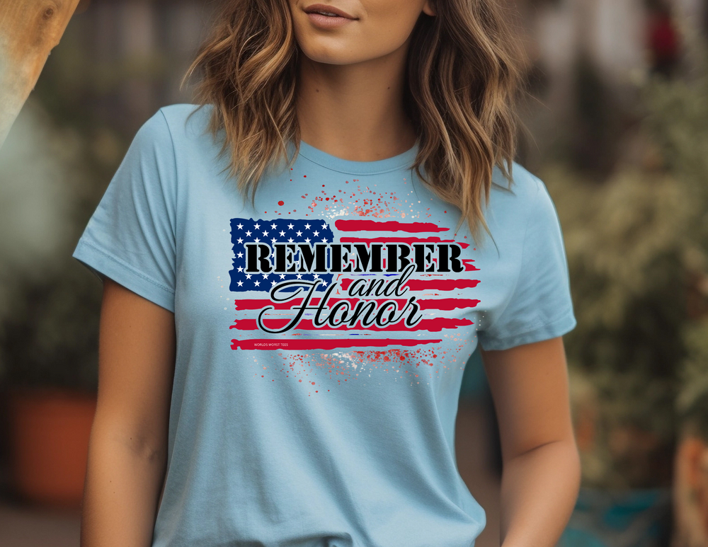 A unisex jersey tee, featuring a woman in a blue shirt. Made of 100% Airlume combed cotton, with ribbed knit collars and taping on shoulders for durability. Product title: Remember and Honor Tee.