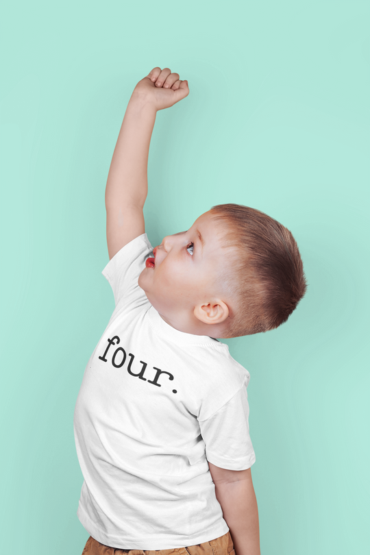 A toddler tee in white, featuring a child raising his hand, with a soft, durable fabric perfect for sensitive skin. Made of 100% combed, ring-spun cotton, with a classic fit.