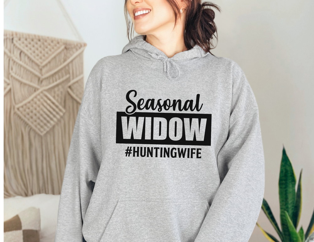 A cozy unisex #Hunting Wife Hoodie in grey, featuring a kangaroo pocket and drawstring hood. Made of cotton-polyester blend for warmth and comfort. Perfect for printing. Classic fit, tear-away label.
