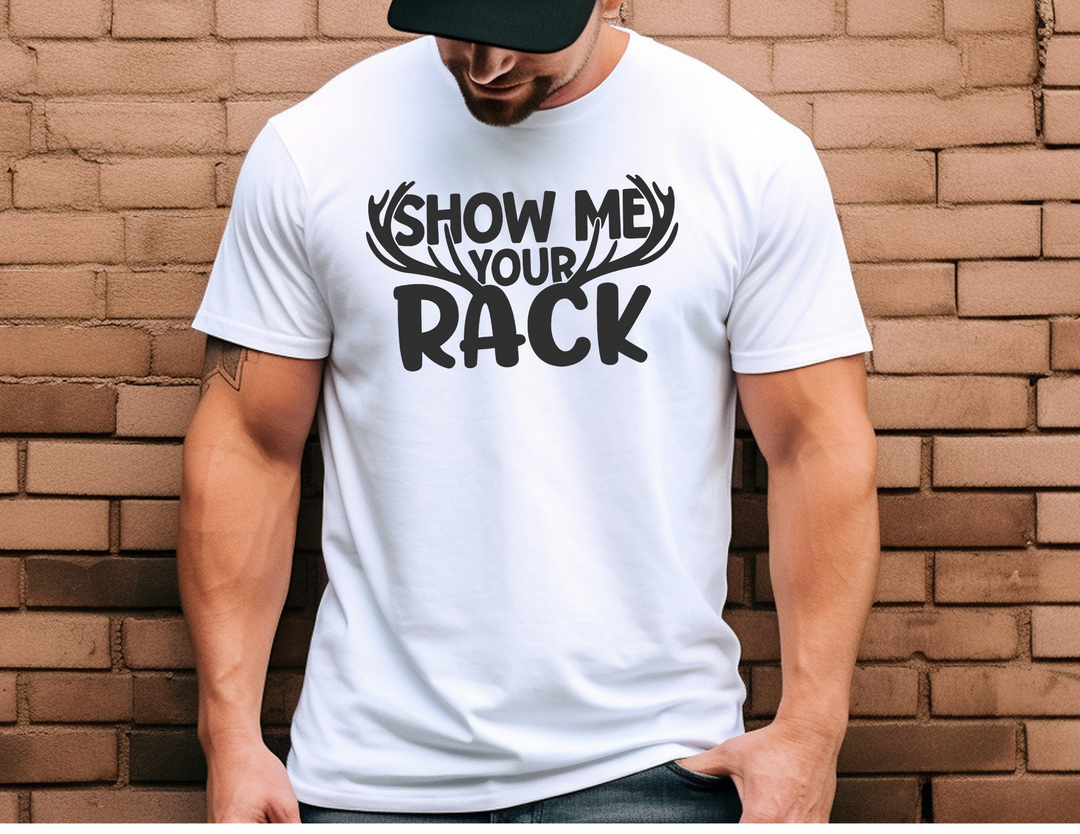 A man in a white Show Me Your Rack Tee, close-up of face and shirt details. Unisex soft-style t-shirt, 100% cotton, tailored fit, twill tape shoulders, no side seams. Casual comfort from Worlds Worst Tees.