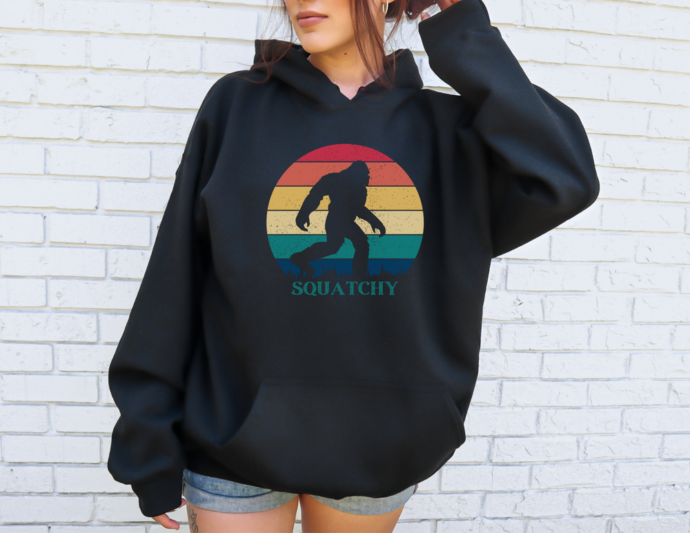 A unisex heavy blend crewneck sweatshirt, Squatchy Hoodie, in black. Comfortable polyester and cotton fabric, ribbed knit collar, loose fit, no itchy side seams. Sizes S to 5XL.