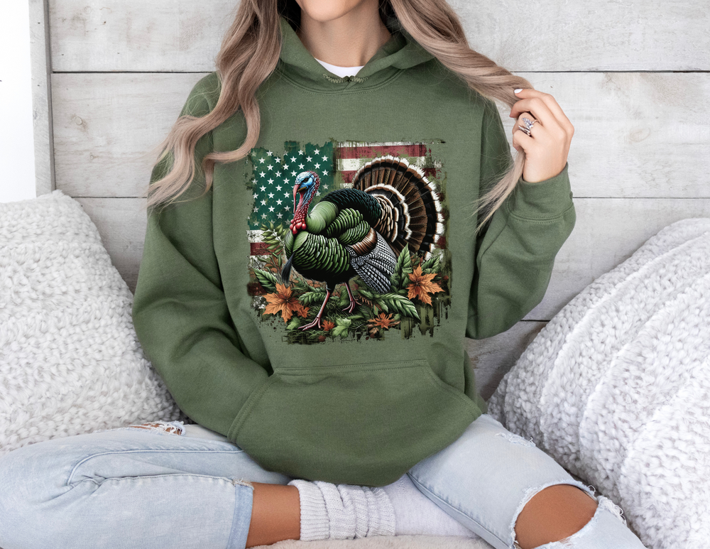A woman in a green turkey hunting hoodie, sitting on a couch. Unisex heavy blend sweatshirt, cotton-polyester fabric, kangaroo pocket, cozy feel, ideal for printing. From Worlds Worst Tees.
