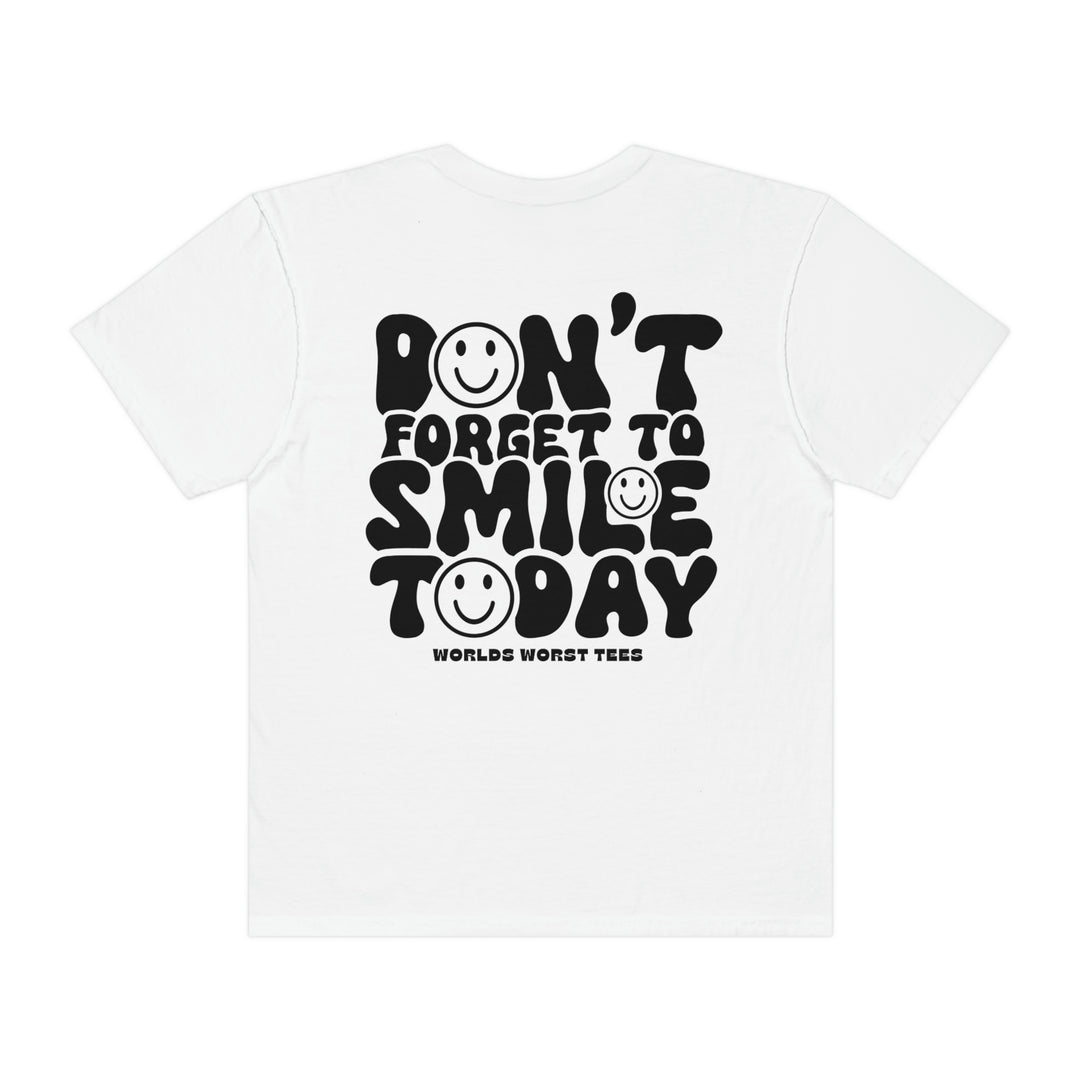 A white t-shirt featuring black text and smiley faces, embodying the Don't Forget To Smile Today Tee from Worlds Worst Tees. Made of 100% ring-spun cotton with a relaxed fit for everyday comfort.