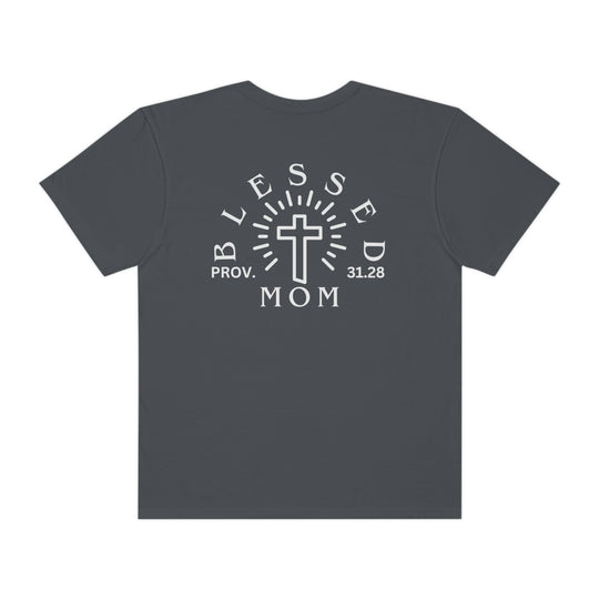 A Blessed Mom Tee, garment-dyed with ring-spun cotton, featuring a white cross design on a grey shirt. Relaxed fit, double-needle stitching, and seamless sides for durability and comfort.