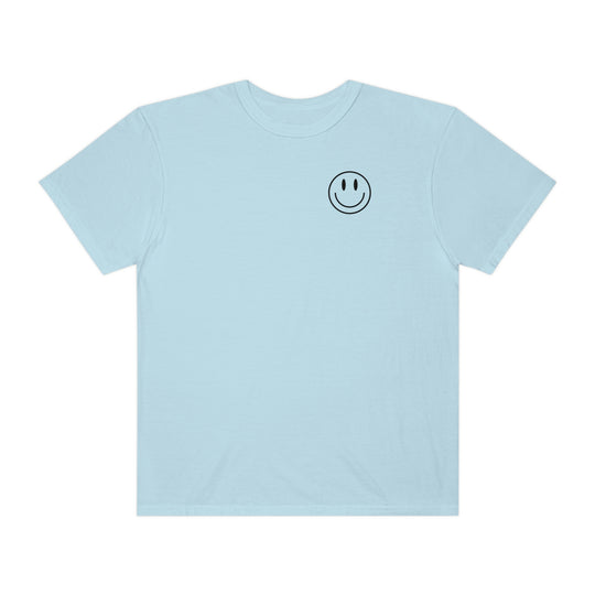 A relaxed-fit, garment-dyed t-shirt featuring a smiley face graphic. Made of 100% ring-spun cotton for coziness and durability. Ideal for daily wear. From 'Worlds Worst Tees'.