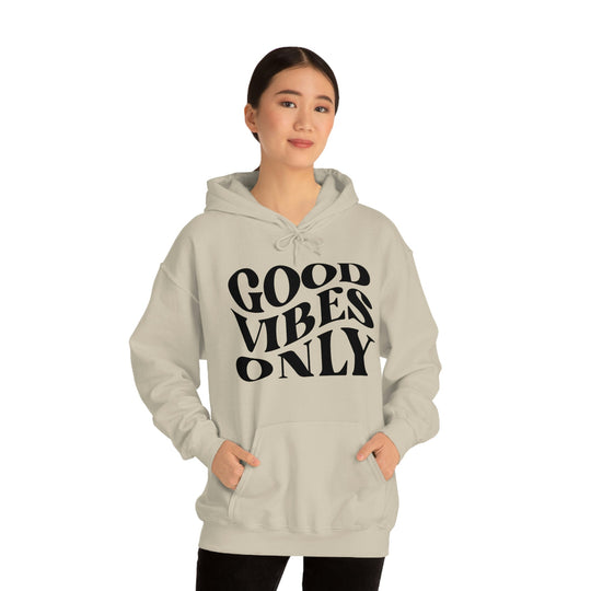 A cozy Good Vibes Only Hoodie, a blend of cotton and polyester, with a kangaroo pocket and drawstring hood. Unisex, medium-heavy fabric, classic fit. Ideal for relaxation and warmth.