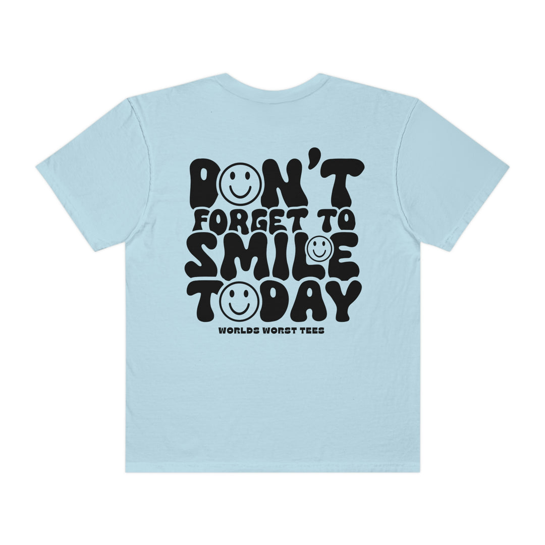 Light blue tee with black text, featuring a smiley face design. 100% ring-spun cotton, garment-dyed for coziness. Relaxed fit, double-needle stitching for durability. From 'Worlds Worst Tees'.