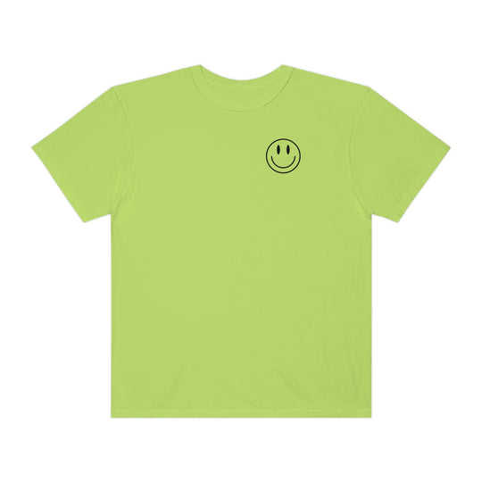 A green t-shirt featuring a smiley face design. Made of 100% ring-spun cotton with a relaxed fit, double-needle stitching, and no side-seams for durability and comfort. From Worlds Worst Tees, the Don't Forget To Smile Today Tee.